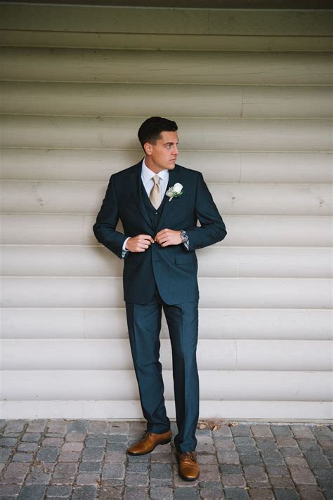 navy suit with taupe tie.